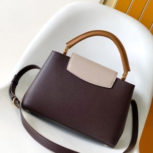 Alternative view of p125031.05 x 20.0 x 11.0 cm (L x H x W)27.0 x 17.3 x 9.0 cm (L x H x W)21.0 x 13.6 x 8.0 cm (L x H x W)•Taurillon calf leather•Calf leather trim•Cowhide leather lining•Metal hardware•Flap can be positioned inside or outside•Zippered interior pocket•Interior patch pocket•Metal studs•Holds smartphone, LV Vertical wallet, headphones, and keys•Shoulder strap: Detachable, adjustable•Strap half-length: 45.5 cm•Strap half-length adjustable to: 53.0 cm•Handle: Single handle